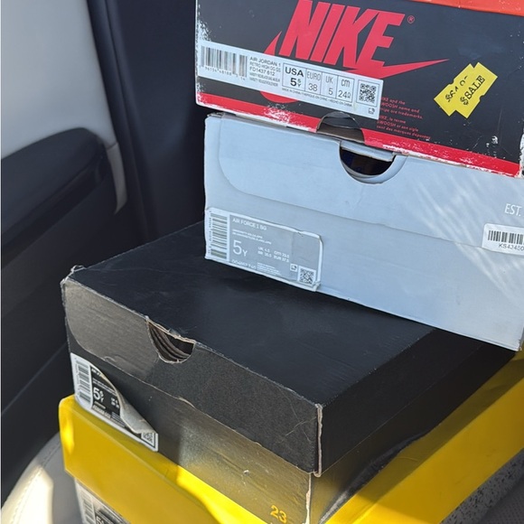 Jordan Shoe Boxes in Red, yellow. Nikes in grey, and black
